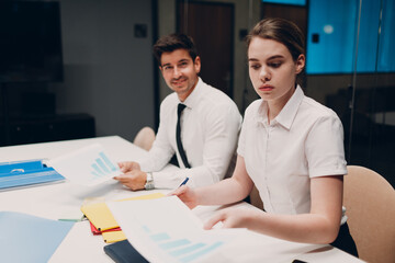Businessman and businesswoman team at office meeting. Business people group conference discussion sit at table with boss man and woman
