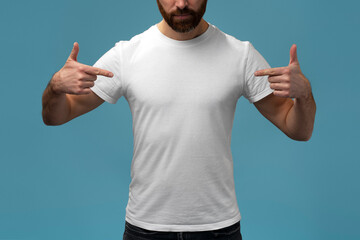 This is me. Closeup of a man in white shirt pointing at himself