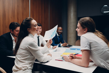 Businessman and businesswoman team at office meeting. Business people group conference discussion sit at table with boss man and woman