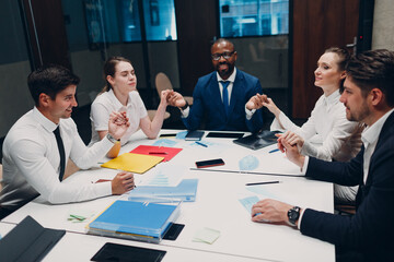 Businessman and businesswoman team meditate and holds hands each other after office meeting. Business people group conference discussion meditation concept