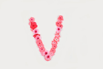 A letter V made from real fresh flowers. Creative floral font concept. Unique collection of letters...