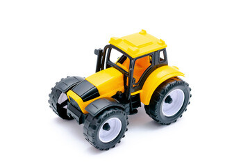 Colorful little mini yellow plastic tractor, truck, lorry, car toy isolated on white background mockup with copy space, toys for children, kids development, playing, childhood fun