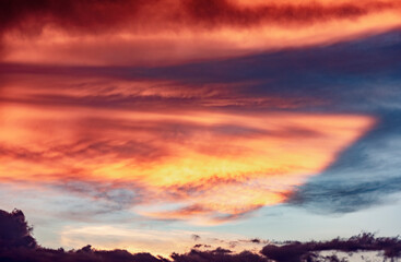 Bright red clouds in a blue sky at sunset in Arizona