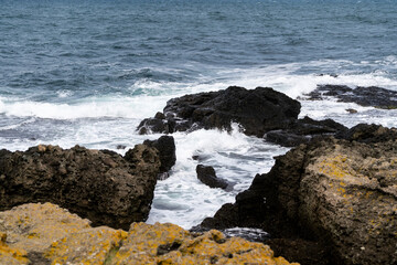 Fototapeta na wymiar Powerful Waves on a rocky beach