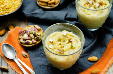 Lentils halwa. Indian sweets in a glass on a wood background