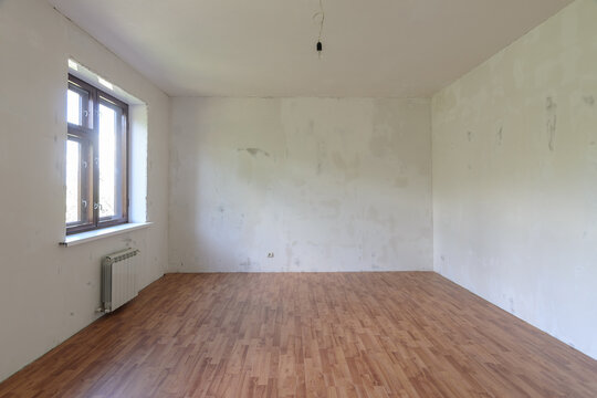 Interior of a small empty room with one window during renovation