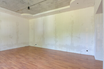 Interior of an empty room after renovation, gray walls, laminate flooring on the floor