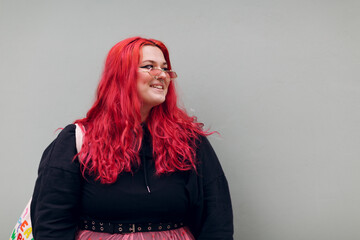 Plus size overweight fat body positive lgbtq woman with red hair and pink glasses.