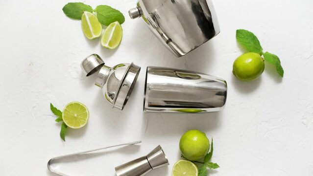 Top View Of Bartenders Coctail Tools Set. Steel Shaker, Measure, Pliers With Lime