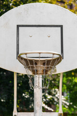 A basketball hoop with a metal chain basket on outdoor playground © Pavel Iarunichev