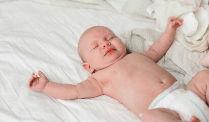 Fototapeta na wymiar Adorable little baby lying on bed