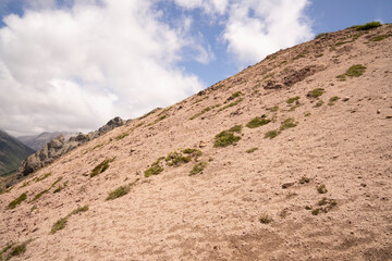 Hiking in the mountain. View of the rocky mountaintop in a sunny day.