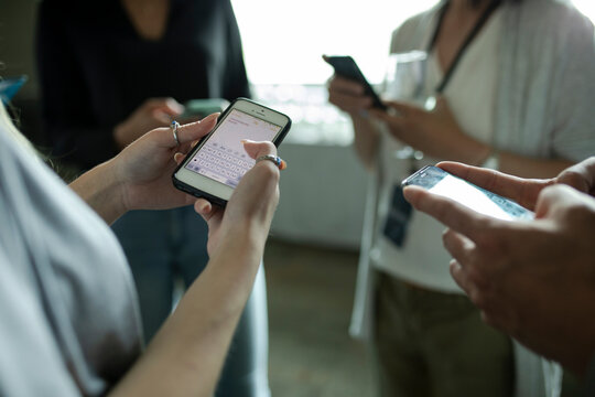 Business People Using Smart Phones In Circle