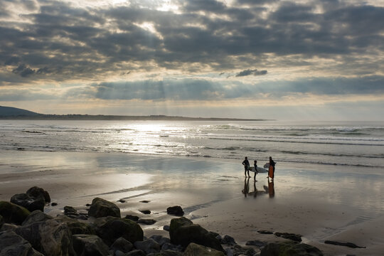 Three Surfers