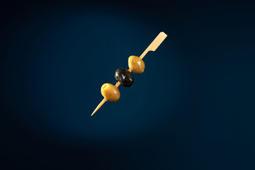 Finger food sticks with olives.