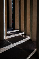 rays of light beam through a building's columns