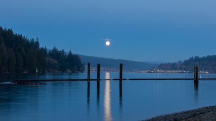 shoreline in the evening during moonrise and blue hour