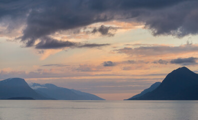 Midnight sun on mountains and the fjord