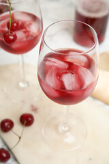 Delicious cherry wine with ripe juicy berries on table