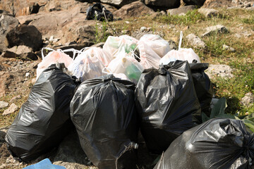 Many trash bags full of garbage outdoors. Environmental Pollution concept