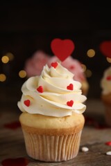 Tasty sweet cupcake on wooden table, closeup. Happy Valentine's Day