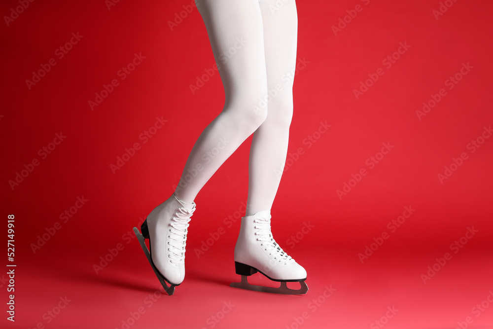 Sticker Woman in elegant white ice skates on red background, closeup of legs