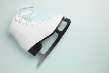 Pink ice skate on light background, top view. Space for text