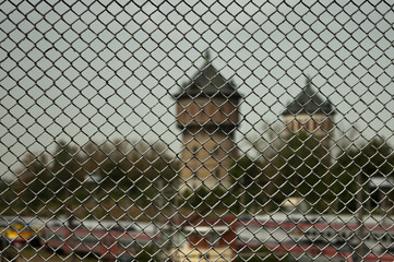 metal mesh, in the photo a mesh chain link against the background of city towers