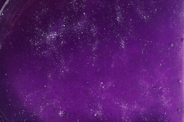 Closeup view of purple slime with glitter as background. Antistress toy