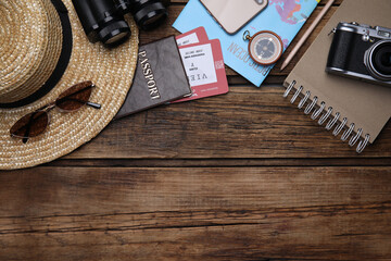 Flat lay composition with passport and tickets on wooden table. Space for text
