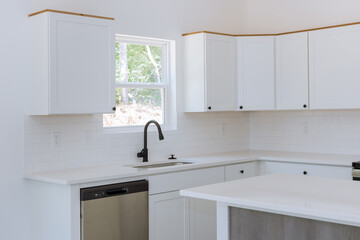 With the installation of new kitchen cabinets, you can see a water tap sink in kitchen.