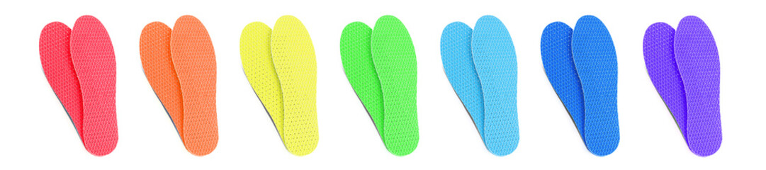 Set with colorful orthopedic insoles on white background, top view. Banner design