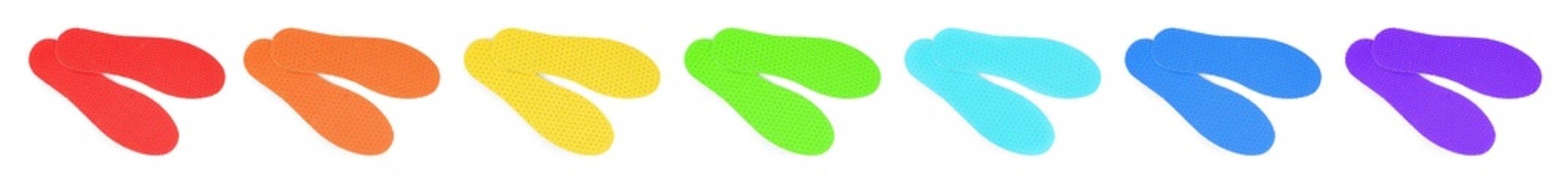 Set with colorful orthopedic insoles on white background, top view. Banner design
