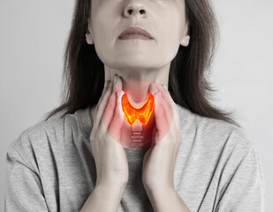 Woman and illustration of thyroid gland on grey background