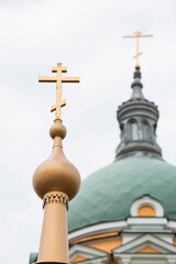 Fototapeta na wymiar The territory of the Zaraisk Kremlin. Orthodox Cathedral of the Beheading of John the Baptist in the Zaraisk Kremlin, Russia. Orthodox cross and domes close-up.