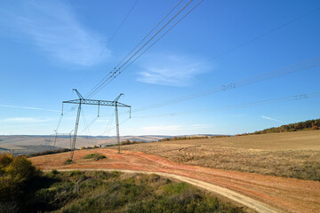 High voltage tower with electric power lines transfening electrical energy through cable wires