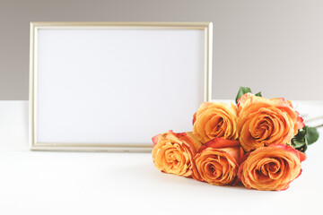 photo frame and orange roses white background