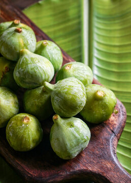 Green ripe figs on rustic wooden table