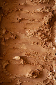 A close-up view of chocolate ice cream in a tub.