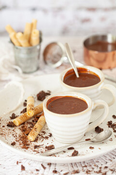 Italian style thick hot chocolate (cioccolata calda) in espresso cups with wafer cigars.