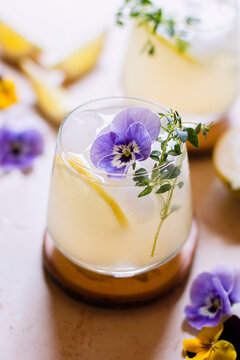 Violet lemonade with sprig of thyme