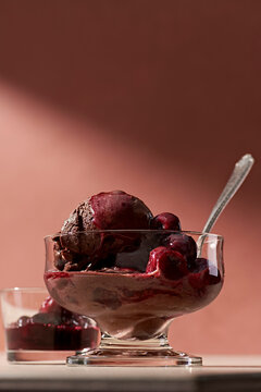 A bowl of chocolate gelato with wine poached cherries.