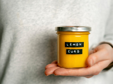 Lemon curd jar in female hand