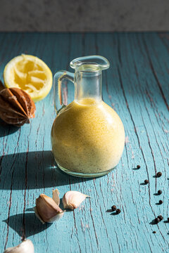 Jug with homemade garlic lemon dressing