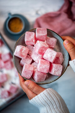 Woman hands holding a bowl of Turkish delights