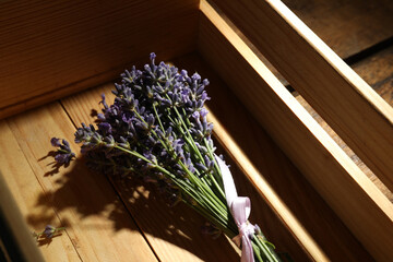 Beautiful fresh lavender bouquet in wooden crate, closeup