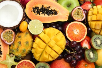 Many different delicious exotic fruits as background, top view