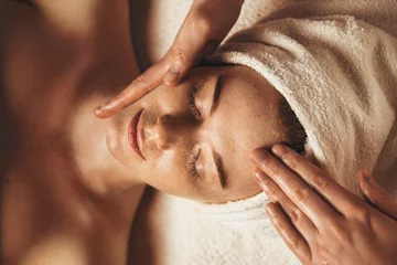 Poster Close-up of young woman getting spa massage treatment at beauty spa salon. Cosmetology beauty skin care anti-aging treatment rejuvenation. Body care, spa © Strelciuc