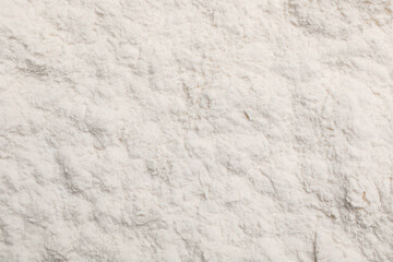 Pile of organic wheat flour as background, top view