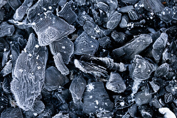 Heating with coal.Frozen coal texture.Heating season.First frosts and colds concept.coal in hoarfrost close-up.Coal industr.